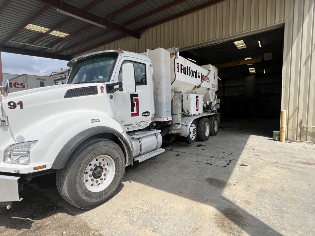 Side view of Cemen Tech M60 volumetric concrete mixer on a Kenworth Chassis